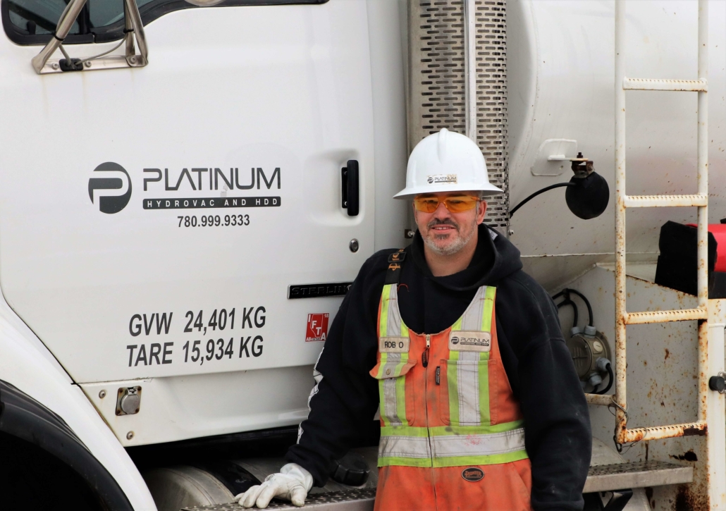 Platinum Employee Rob O standing in front of a platinum truck smiling