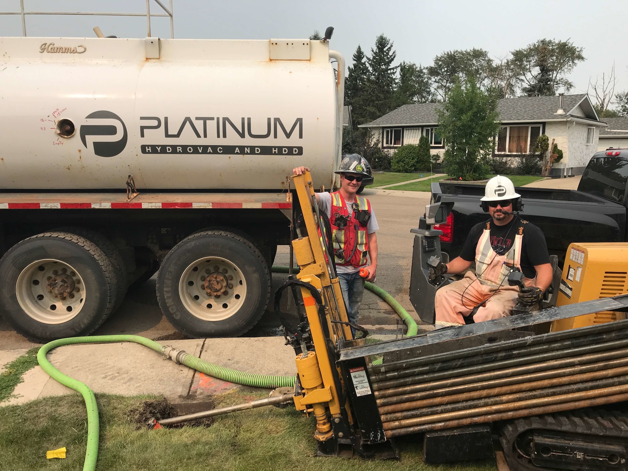 Two platinum team members, standing around the horizontal directional drill